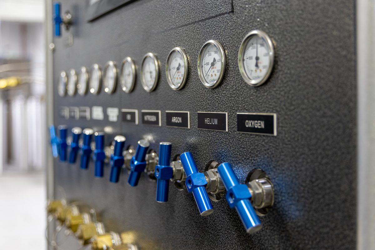 WSM specialty gas blending station — two lab technicians operating precision gas valve manifold